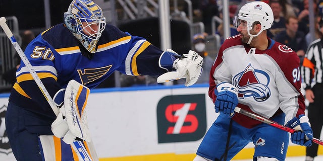 Jordan Binnington (50) of the St. Louis Blues makes a save against Nazem Kadri (91) of the Colorado Avalanche in the first period at Enterprise Center on Oct. 28, 2021, in St Louis, Missouri.