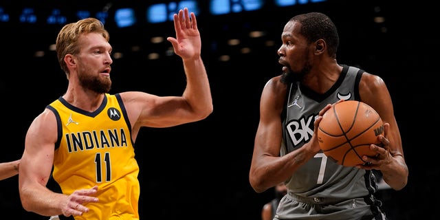 Indiana Pacers forward Domantas Sabonis (11) defends against Brooklyn Nets forward Kevin Durant (7) during the second half of an NBA basketball game, Friday, Oct. 29, 2021, in New York. The Nets won 105-98.