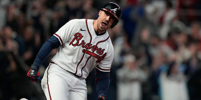 Atlanta Brave Adam Duvall celebrates his grand slam home run during the first inning in Game 5 of baseball's World Series between the Houston Astros and the Braves Sunday, Okt.. 31, 2021, in Atlanta.