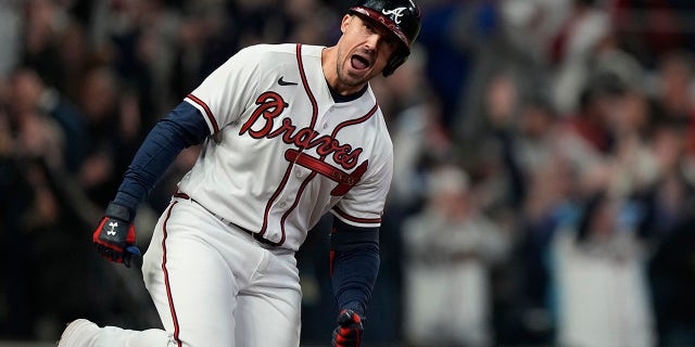 Atlanta Brave Adam Duvall celebrates his grand slam home run during the first inning in Game 5 of baseball's World Series between the Houston Astros and the Braves Sunday, Oct. 31, 2021, in Atlanta.