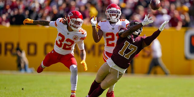 Washington Football Team wide receiver Terry McLaurin (17) reaches out but misses the catch as he covered by Kansas City Chiefs free safety Tyrann Mathieu (32) and cornerback Mike Hughes (21) during the first half of an NFL football game, Sunday, Oct. 17, 2021, in Landover, Md.