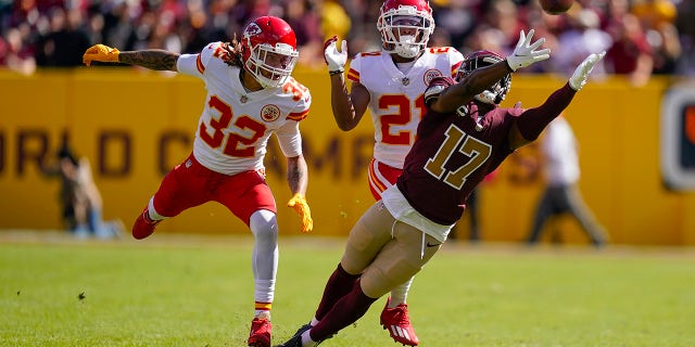 Washington Football Team wide receiver Terry McLaurin (17) reaches out but misses the catch as he covered by Kansas City Chiefs free safety Tyrann Mathieu (32) and cornerback Mike Hughes (21) during the first half of an NFL football game, Sunday, Oct. 17, 2021, in Landover, Md.