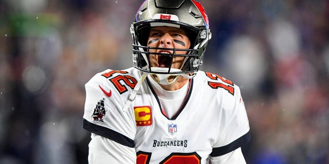 Tampa Bay Buccaneers quarterback Tom Brady (12) yells to the crowd as he takes the field to face the New England Patriots at Gillette Stadium.