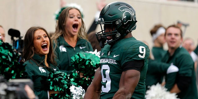 Michigan State's Kenneth Walker III celebrates his touchdown against Michigan during the second quarter of an NCAA college football game, Saturday, Oct. 30, 2021, in East Lansing, Mich.