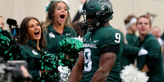Michigan State's Kenneth Walker III celebrates his touchdown against Michigan during the second quarter of an NCAA college football game, Saturday, Oct. 30, 2021, in East Lansing, Mich.