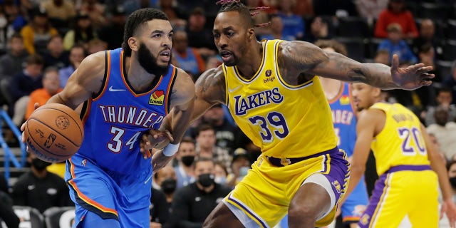 Oklahoma City Thunder forward Kenrich Williams (34) goes against Los Angeles Lakers center Dwight Howard (39) during the second half of an NBA basketball game, Wednesday, Oct. 27, 2021, in Oklahoma City.