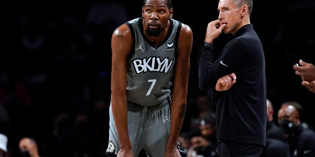 Brooklyn Nets forward Kevin Durant (7) talks to coach Steve Nash during the first half against the Indiana Pacers, Oct. 29, 2021, in New York.