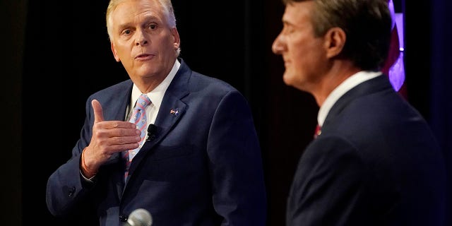 Democratic gubernatorial candidate former Governor Terry McAuliffe, left, gestures as Republican challenger, Glenn Youngkin, listens during a debate at the Appalachian School of Law in Grundy, Va., Thursday, Sept. 16, 2021. (AP Photo/Steve Helber)