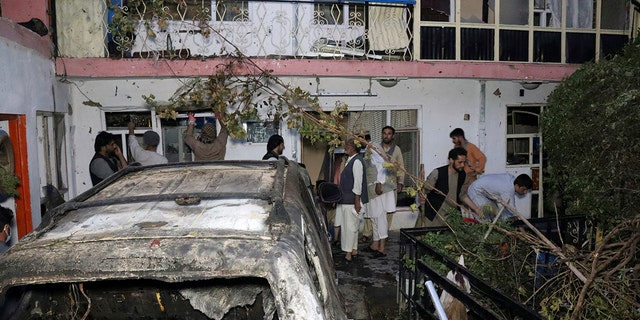 Afghans inspect damage at the Ahmadi family house after a U.S. drone strike in Kabul, Afghanistan, on Aug. 29, 2021.