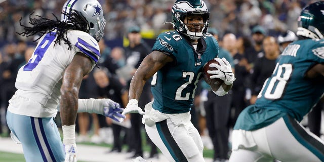 Dallas Cowboys linebacker Jaylon Smith (9) gives chase as Philadelphia Eagles running back Miles Sanders (26) runs the ball in the second half of an NFL football game in Arlington, Texas, Monday, Sept. 27, 2021. (AP Photo/Michael Ainsworth)