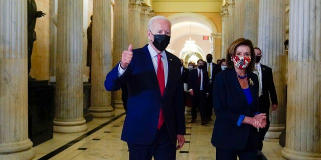 President Joe Biden gives a thumbs up as he walks with House Speaker Nancy Pelosi of Calif., on Capitol Hill in Washington, Friday, Oct. 1, 2021.