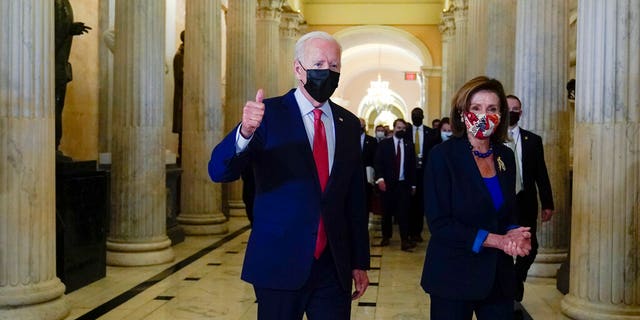 President Joe Biden gives a thumbs up as he walks with Speaker of the House Nancy Pelosi of California (AP Photo / Susan Walsh)