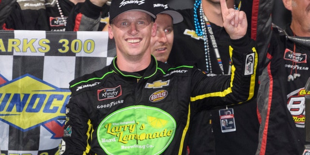 Brandon Brown celebrates in Victory Lane after winning a NASCAR Xfinity Series auto race Saturday, Oct. 2, 2021, in Talladega, Ala. (AP Photo/John Amis)