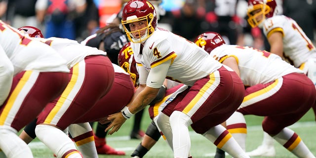 Washington Football Team quarterback Taylor Heinicke (4) works against the Atlanta Falcons during the first half of an NFL football game, Sunday, Oct. 3, 2021, in Atlanta. (AP Photo/Brynn Anderson)