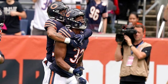 Chicago Bears running back David Montgomery (32) celebrates his touchdown with a teammate during the first half of an NFL football game against the Detroit Lions on Sunday, October 3, 2021, in Chicago.  (AP Photo / Nam Y. Huh)