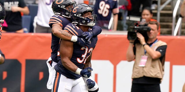 Chicago Bears running back David Montgomery (32) celebrates his touchdown with a teammate during the first half of an NFL football game against the Detroit Lions Sunday, Oct. 3, 2021, in Chicago. (AP Photo/Nam Y. Huh)