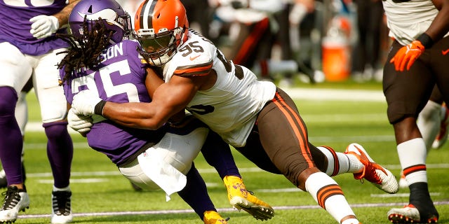 Minnesota Vikings running back Alexander Mattison (25) is tackled by Cleveland Browns defensive end Myles Garrett (95) during the second half of an NFL football game, Sunday, Oct. 3, 2021, in Minneapolis. (AP Photo/Bruce Kluckhohn)