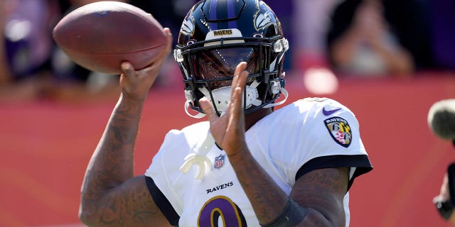 Baltimore Ravens quarterback Lamar Jackson (8) warms up prior to an NFL football game against the Denver Broncos, Sunday, Oct. 3, 2021, in Denver.