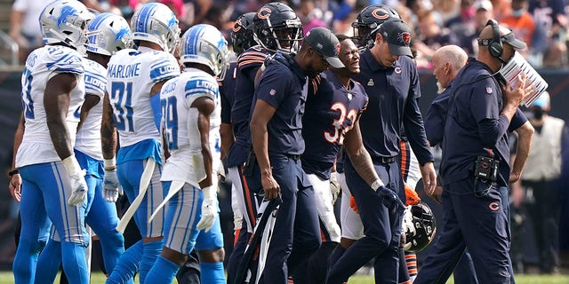 Chicago Bears running back David Montgomery (32) grimaces in pain as he leaves the field after being injured in the second half of an NFL football game against the Detroit Lions on Sunday 3 October 2021, in Chicago.