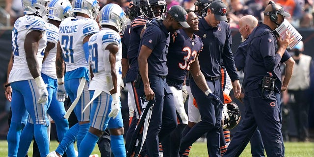 Chicago Bears running back David Montgomery (32) grimaces in pain as he leave the field after being injured during the second half of an NFL football game against the Detroit Lions Sunday, Oct. 3, 2021, in Chicago.