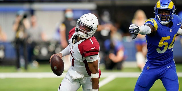 Arizona Cardinals quarterback Kyler Murray, left, avoids the rush from Los Angeles Rams outside linebacker Leonard Floyd during the first half in an NFL football game Sunday, Oct. 3, 2021, in Inglewood, California.