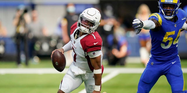 Arizona Cardinals quarterback Kyler Murray, left, avoids the rush from Los Angeles Rams outside linebacker Leonard Floyd during the first half in an NFL football game Sunday, Oct. 3, 2021, in Inglewood, California.