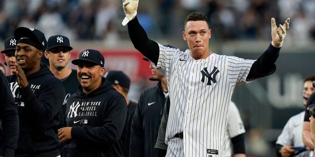 The New York Yankees' Aaron Judge, right, gestures to fans after a game against the Tampa Bay Rays Oct. 3, 2021, in New York. 