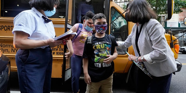 Students are greeted by faculty as they arrive at PS811 in New York, Monday, Sept. 13, 2021.  (AP Photo/Richard Drew, File)