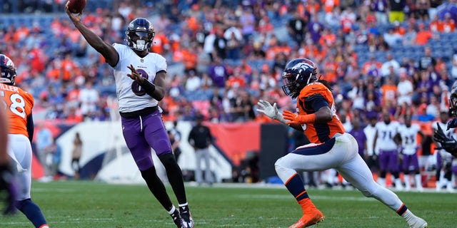 Baltimore Ravens quarterback Lamar Jackson (8) throws as Denver Broncos linebacker A.J. Johnson pursues during the second half of an NFL football game, Sunday, Oct. 3, 2021, in Denver.