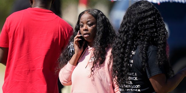 People gather on a road leading to Timberview High School after a shooting at the school in south Arlington, Texas on Wednesday. (AP Photo/LM Otero)