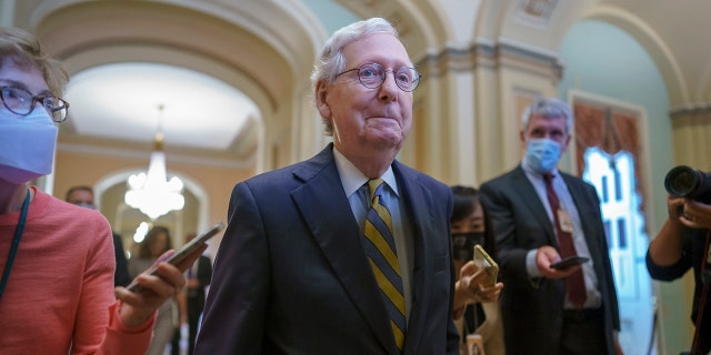 Senate Minority Leader Mitch McConnell, R-Ky., is surrounded by journalists as he walks to the Senate Chamber for a vote as Democrats look for a way to lift the debt limit without Republican votes, at the Capitol in Washington, Wednesday, Oct. 6, 2021. (AP Photo/J. Scott Applewhite)