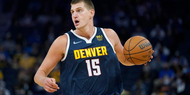 Denver Nuggets center Nikola Jokic dribbles aduring the first half of the team's preseason NBA basketball game against the Golden State Warriors in San Francisco, Wednesday, Oct. 6, 2021. (AP Photo/Jeff Chiu)