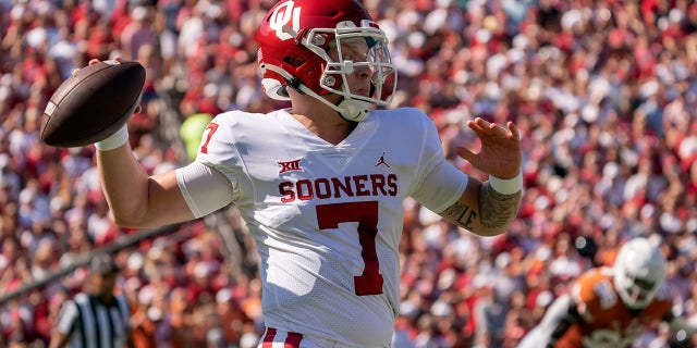 Oklahoma quarterback Spencer Rattler (7) throws downfield against Texas during the first half of an NCAA college football game at the Cotton Bowl, Saturday, Oct. 9, 2021, in Dallas. (AP Photo/Jeffrey McWhorter)