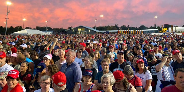 People gather ahead of an appearance by former President Donald Trump at a rally at the Iowa State Fairgrounds in Des Moines, Iowa., Saturday, Oct. 9, 2021. (AP Photo/Thomas Beaumont)