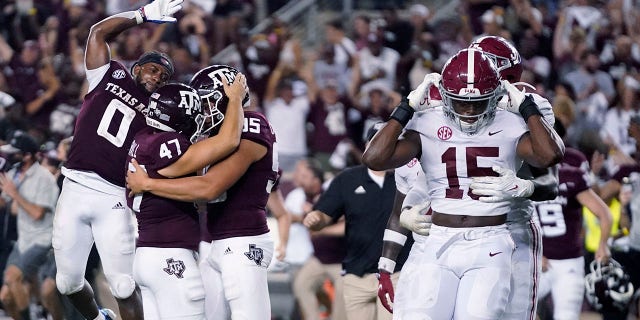 Texas A&M's Seth Small (47) celebrates with Nik Constantinou (95) and Ainias Smith (0) after his game-winning field goal, as Alabama linebackers Dallas Turner (15) and Will Anderson Jr. leave the field after an NCAA college football game Saturday, Oct. 9, 2021, in College Station, Texas. (AP Photo/Sam Craft)