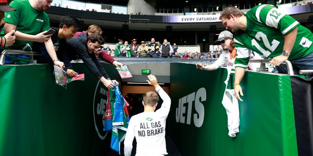 New York Jets quarterback Zach Wilson leaves the field after the first warm-up before an NFL football game between the Jets and the Atlanta Falcons at the Tottenham Hotspur stadium in London, England, Sunday, Oct. 10, 2021.