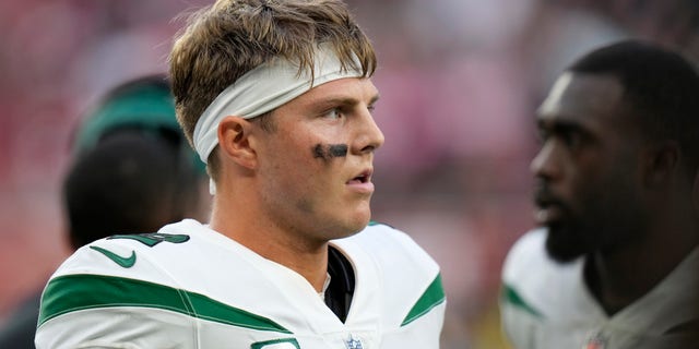 New York Jets quarterback Zach Wilson stands on the field after an NFL football game between the New York Jets and the Atlanta Falcons at the Tottenham Hotspur stadium in London, England, Sunday, Oct. 10, 2021. Atlanta won the match 27-20.
