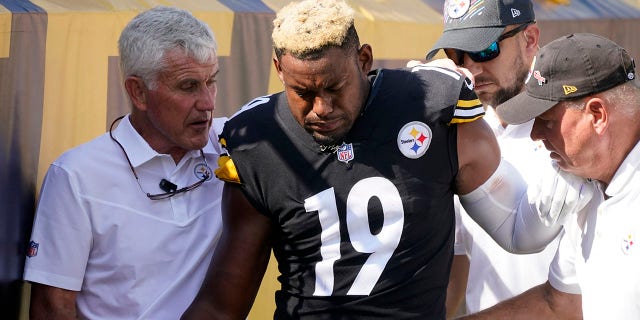 Pittsburgh Steelers wide receiver JuJu Smith-Schuster (19) is helped off the field after being injured during the first half of an NFL football game against the Denver Broncos in Pittsburgh, Sunday, Oct. 10, 2021. (AP Photo/Keith Srakocic)