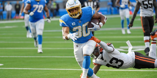 Los Angeles Chargers running back Austin Ekeler scores a touchdown past Cleveland Browns free safety John Johnson (43) during the second half Sunday.