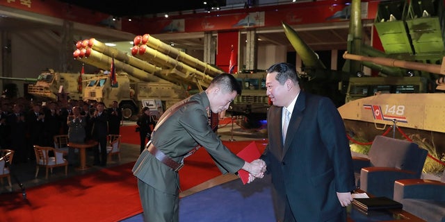 Kim reviewed the rare exhibition and vowed to build an "invincible" military, as he accused the United States of creating regional tensions and lacking action to prove it has no hostile intent toward the North, state media reported Tuesday.