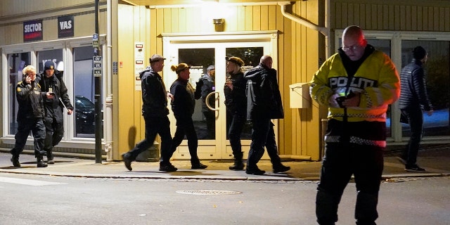 Police work at the scene where an arrow was shot into a wall in Kongsberg, Norway, Wednesday, Oct. 13, 2021. (Torstein Bøe/NTB via AP)