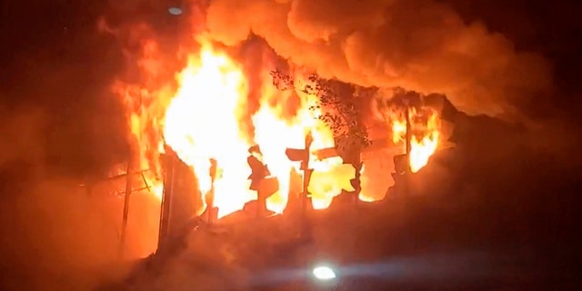 In this image taken from video by Taiwan's EBC, fire and smoke pour out from a building in Kaohsiung, in southern Taiwan on Thursday, Oct. 14, 2021. The fire engulfed a 13-story building overnight in southern Taiwan, the island's semi-official Central News Agency reported Thursday. (EBC via AP )