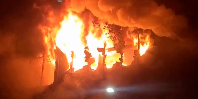 In this image taken from video by Taiwan's EBC, fire and smoke pour out from a building in Kaohsiung, in southern Taiwan on Thursday, Oct. 14, 2021. The fire engulfed a 13-story building overnight in southern Taiwan, the island's semi-official Central News Agency reported Thursday. (EBC via AP )