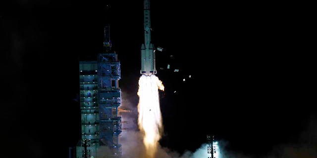 The crewed spaceship Shenzhou-13, atop a Long March-2F carrier rocket, is launched from the Jiuquan Satellite Launch Center in northwest China's Gobi Desert Oct. 16, 2021.