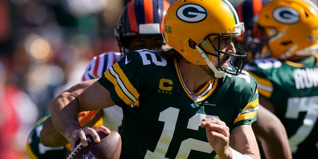 Green Bay Packers quarterback Aaron Rodgers scrambles during the first half of an NFL football game against the Chicago Bears Sunday, Oct. 17, 2021, in Chicago. (AP Photo/Nam Y. Huh)