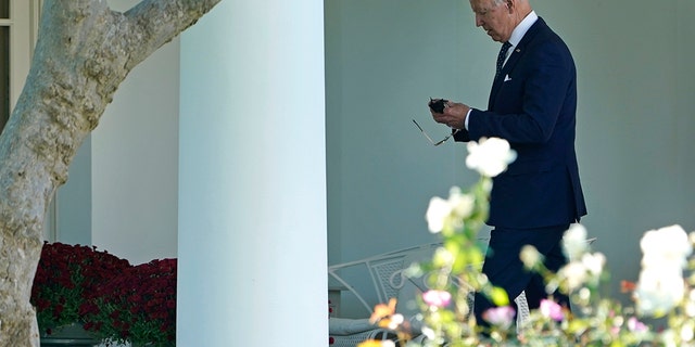 Oct. 18, 2021: President Joe Biden puts his mask back on as he walks back to the Oval Office. (AP Photo/Susan Walsh)