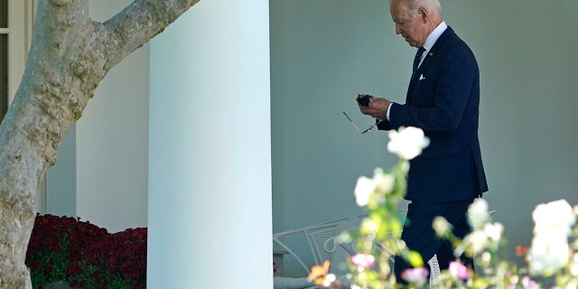 Oct. 18, 2021: President Joe Biden puts his mask back on as he walks back to the Oval Office. (Associated Press)