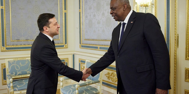 Ukrainian President Volodymyr Zelenskyy, left, shakes hands with U.S. Defense Secretary Lloyd Austin III during their meeting in Kiev, Ukraine, Tuesday, Oct. 19, 2021. (Ukrainian Presidential Press Office via AP)