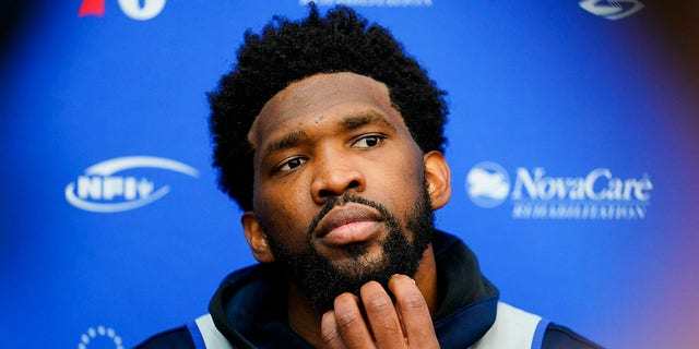 Philadelphia 76ers' Joel Embiid speaks with members of the media at the NBA basketball team's facility, Tuesday, Oct. 19, 2021, in Camden, New Jersey. (AP Photo/Matt Rourke)