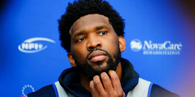 Philadelphia 76ers' Joel Embiid speaks with members of the media at the NBA basketball team's facility, Tuesday, Oct. 19, 2021, in Camden, New Jersey. (AP Photo/Matt Rourke)